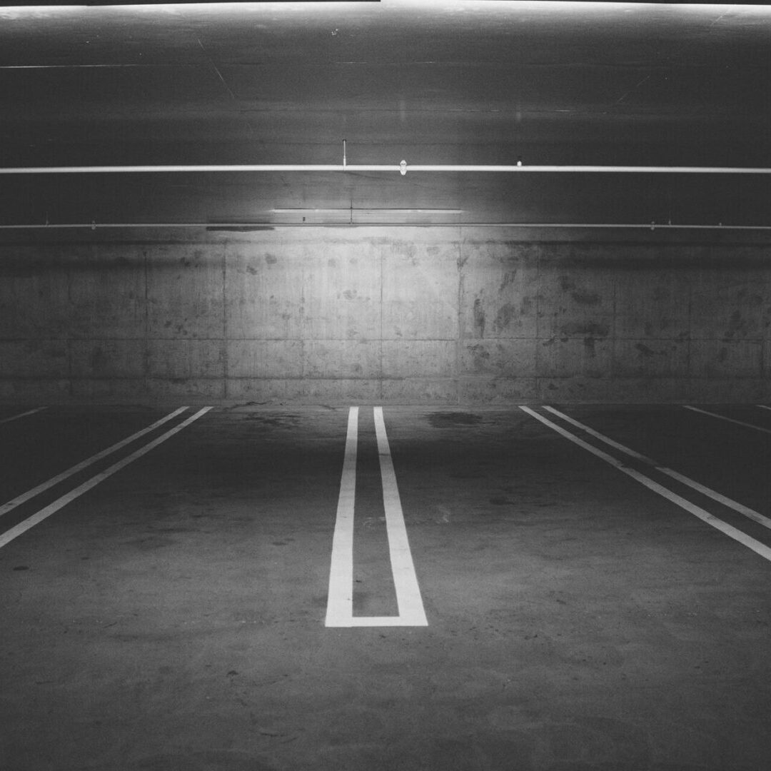 A parking lot with two lines painted on the ground.